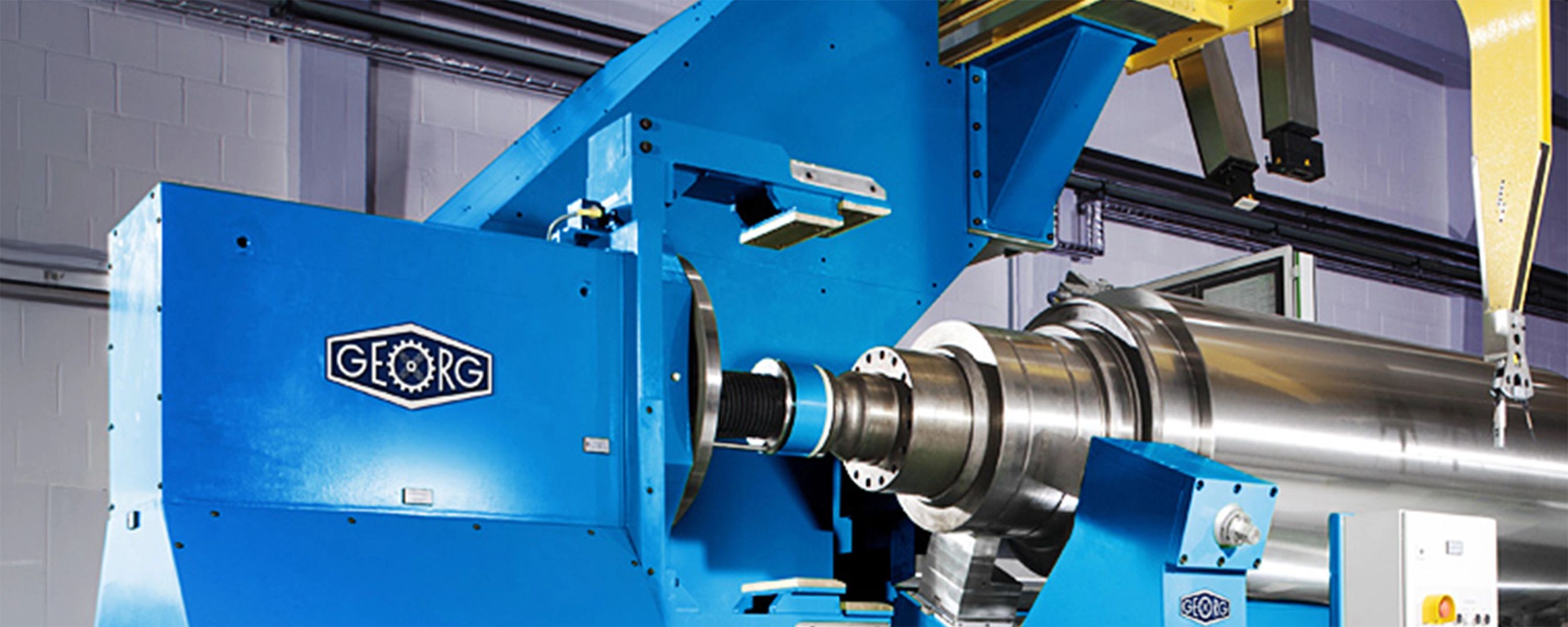 Präzisionsmaschine von Heinrich Georg – industrielle Hochleistungsanlage in blauem Design für die Metallbearbeitung und Fertigung von Walzen und Komponenten.