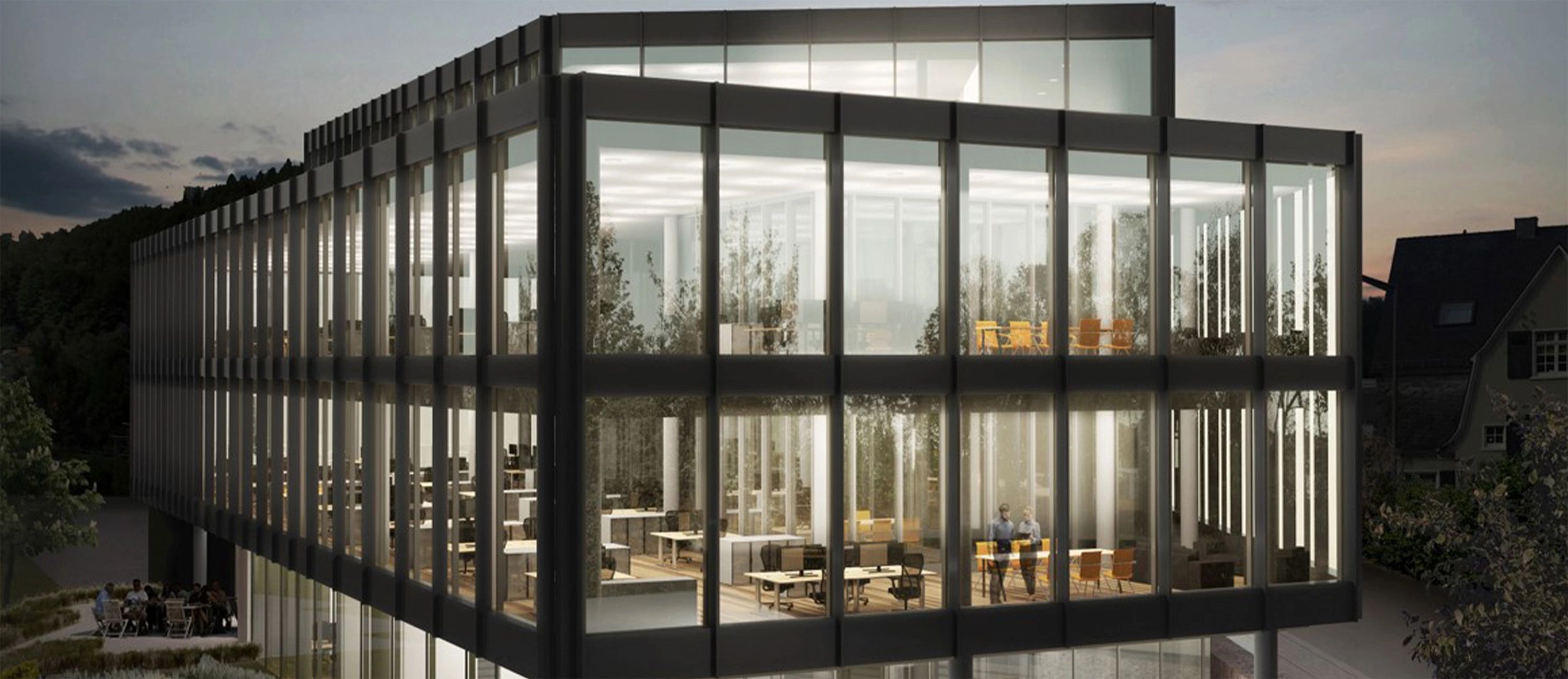 Hauptsitz der HF Mixing Group – modernes, verglastes Bürogebäude in Abendbeleuchtung, Symbol für Innovation, Technologiekompetenz und industrielle Mischtechnik.