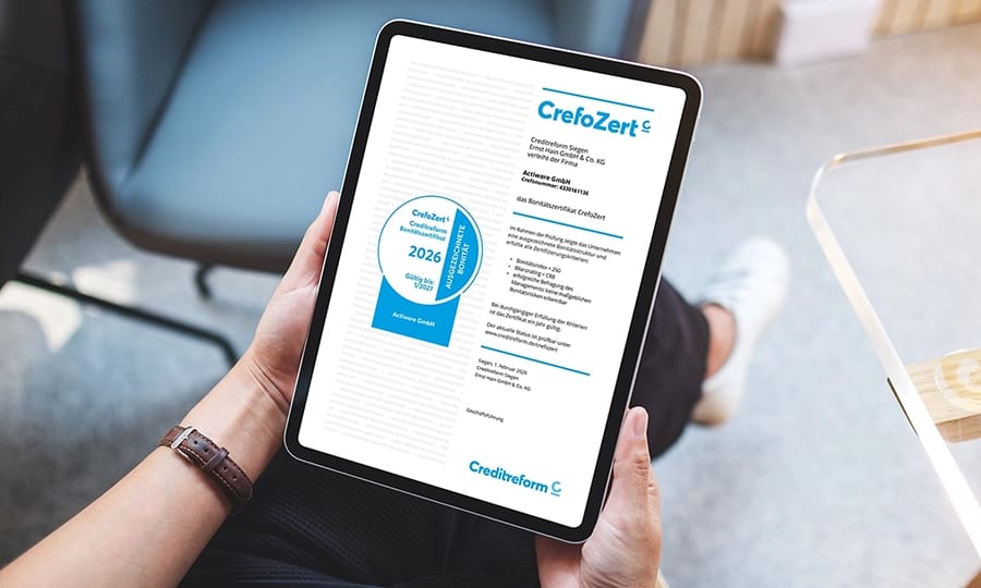CrefoZert-Auszeichnung 2026 für ACTIWARE GmbH auf Tablet.