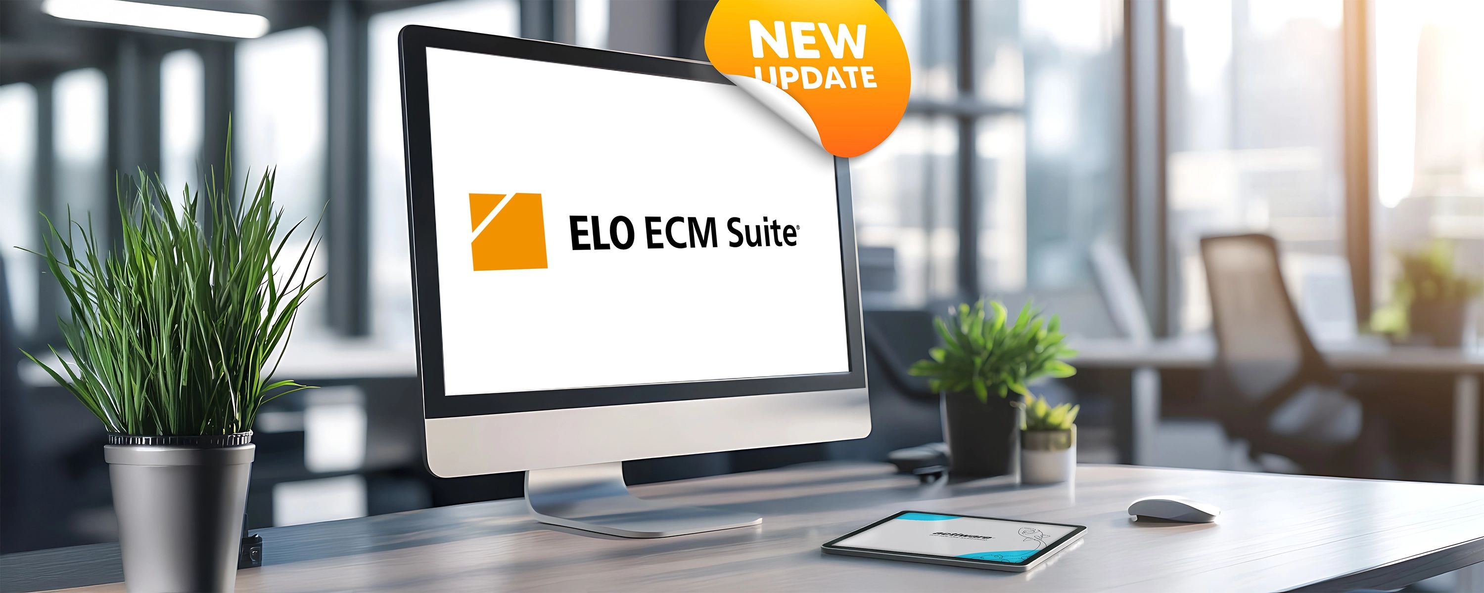 Das Logo der ELO ECM Suite mit einem "New Update"-Sticker, angezeigt auf einem Computerbildschirm an einem modernen Arbeitsplatz.