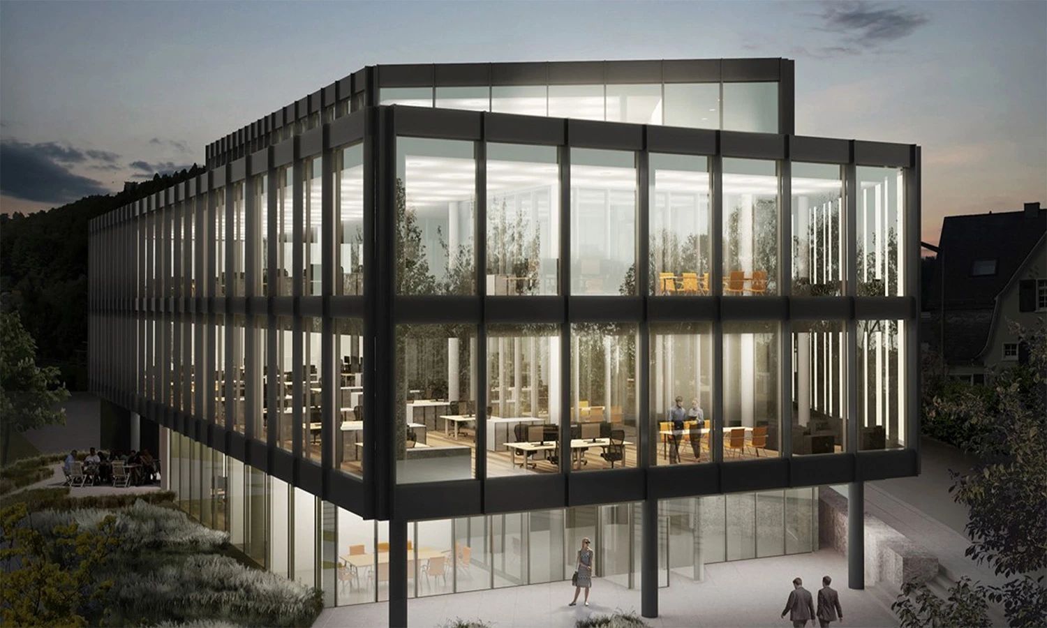 Hauptsitz der HF Mixing Group – modernes, verglastes Bürogebäude in Abendbeleuchtung, Symbol für Innovation, Technologiekompetenz und industrielle Mischtechnik.